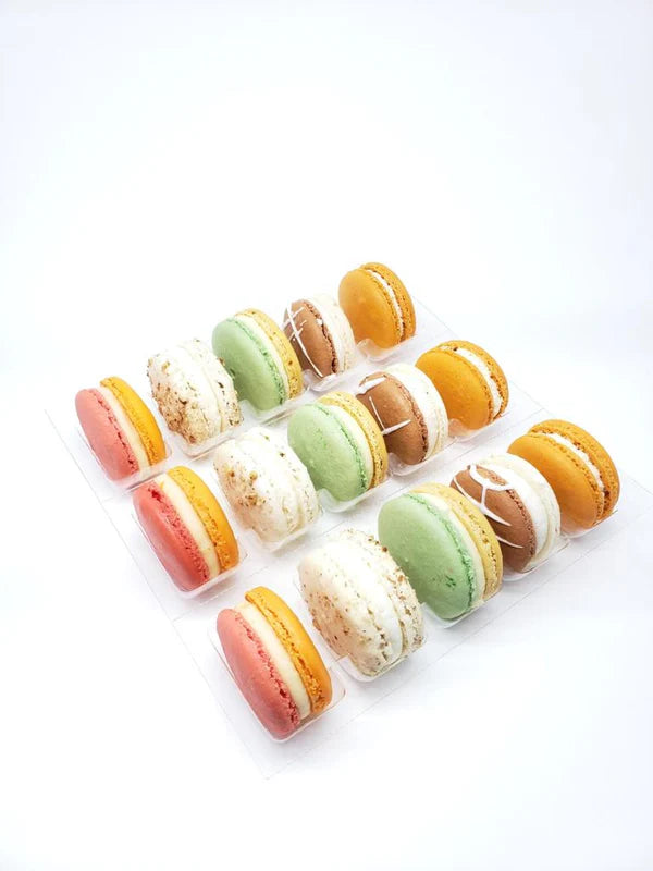 Assorted colorful macarons arranged in a grid on a white background Main image